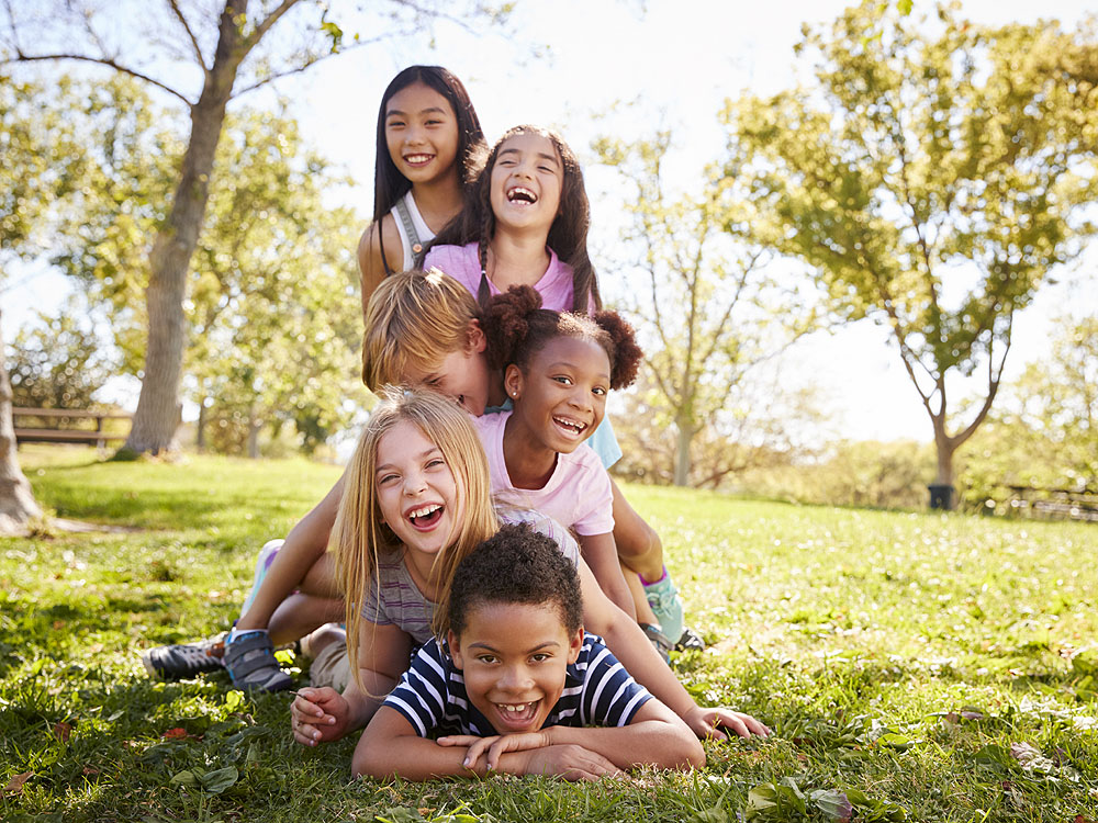 multi-ethnic-group-of-children-lying-in-a-pile750X1000